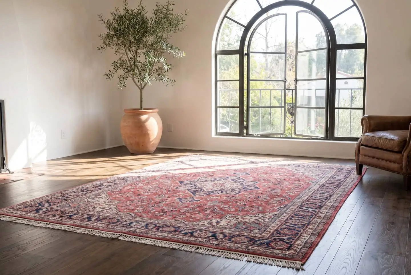 Illustration: a Spanish revival living room with a Persian-style rug.