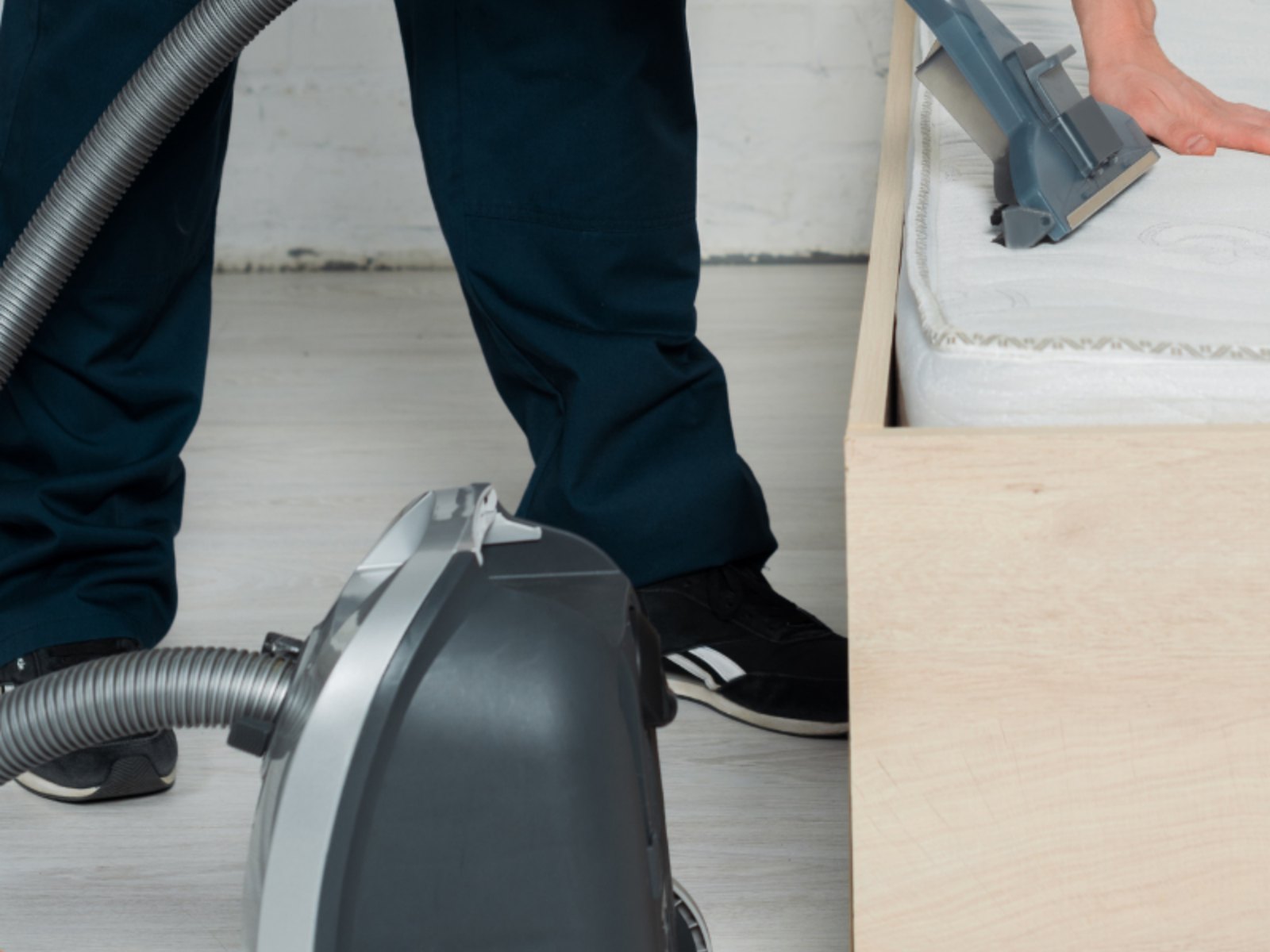 A technician in uniform working with a cleaning machine indoors